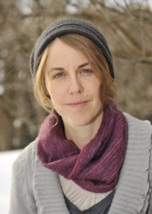 Rebecca Barnstaple wearing a grey hat and sweater and a purple scarf